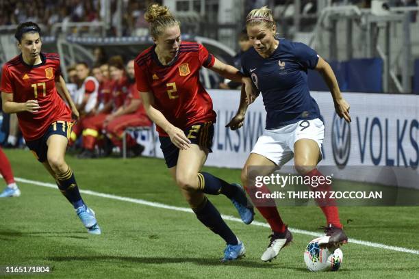France's forward Eugenie Le Sommer fights for the ball with Spain's defender Celia Jimenez and Spain's forward Lucia Garcia during the international...