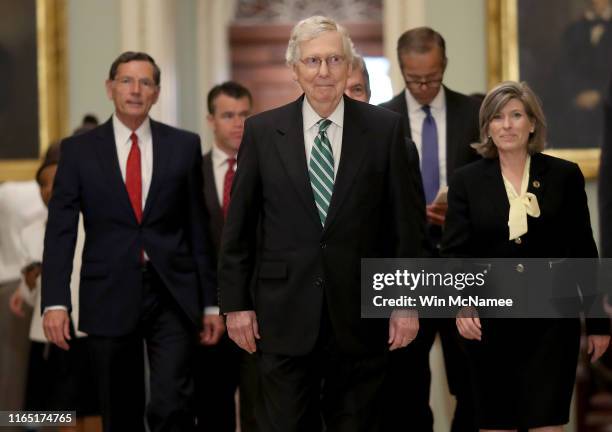 Senate Majority Leader Mitch McConell walks to a press conference with fellow Republicans following the weekly Republican policy luncheon on July 30,...