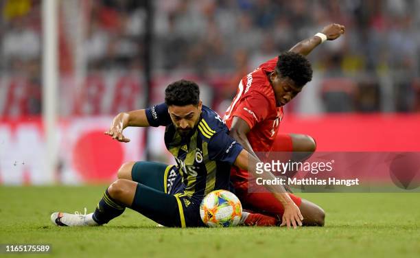 David Alaba of Muenchen challenges Mehmet Ekici of Fenerbahce during the Audi Cup 2019 semi final match between FC Bayern Muenchen and Fenerbahce at...