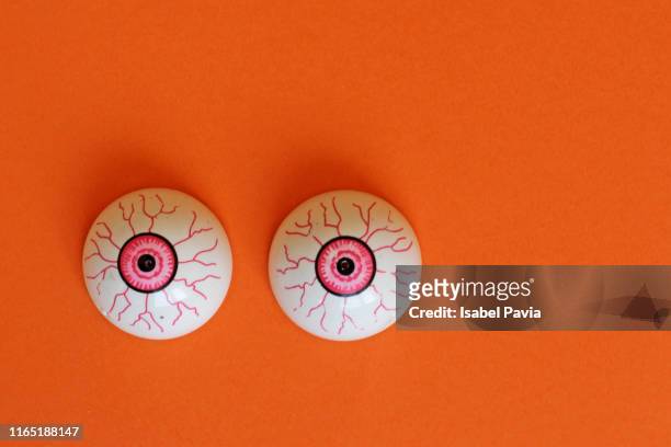 eyes on orange background. halloween concept - dry eye stock pictures, royalty-free photos & images