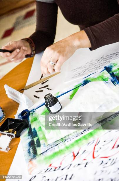 woman with calligraphy materials on table - kalligraphieren stock-fotos und bilder