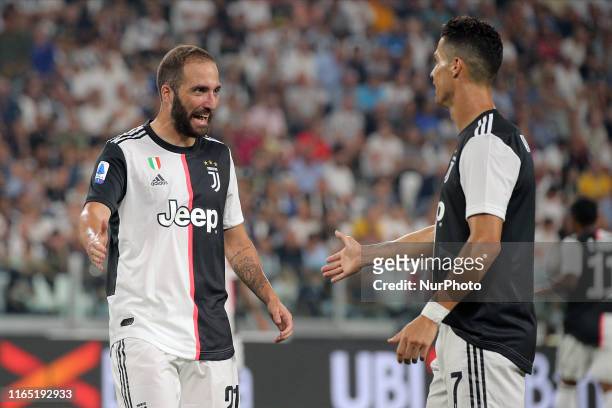 Gonzalo Higuain celebrates with Cristiano Ronaldo during the Serie A match between Juventus and SSC Napoli at Allianz Stadium on August 31, 2019 in...