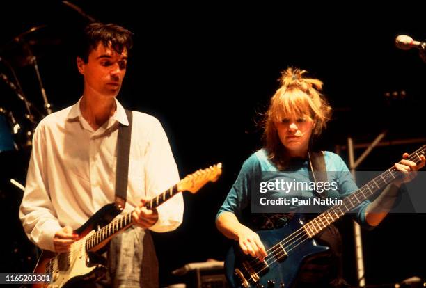 New Wave musicians David Byrne , on guitar, and Tina Weymouth, on bass guitar, both of the group Talking Heads, performs onstage at the Poplar Creek...