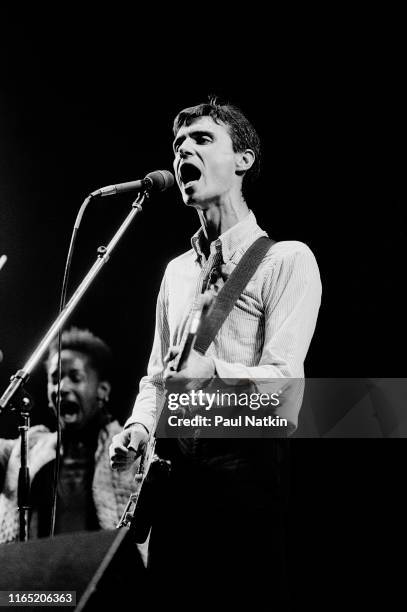 British/American New Wave musician David Byrne, of the group Talking Heads, plays guitar as he performs onstage at the Aragon Ballroom, Chicago,...