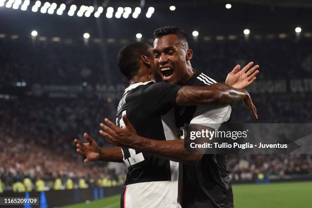 Douglas Costa and Alex Sandro of Juventus celebrate after own goal of Kalidou Koulibaly of SSC Napoli during the Serie A match between Juventus and...