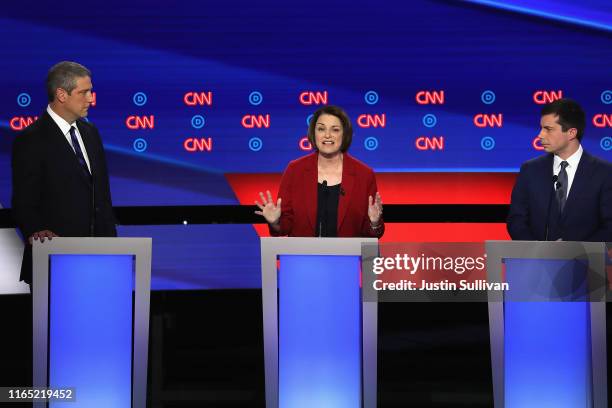 Democratic presidential candidate Sen. Amy Klobuchar speaks while Rep. Tim Ryan and South Bend, Indiana Mayor Pete Buttigieg listen during the...