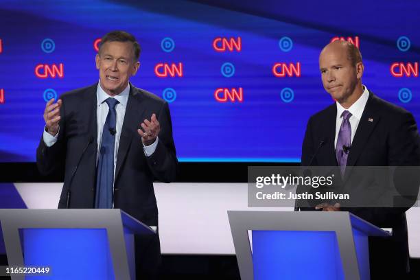 Democratic presidential candidate former Colorado governor John Hickenlooper speaks while former Maryland congressman John Delaney listens during the...