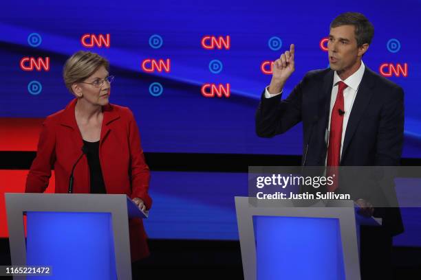 Democratic presidential candidate former Texas congressman Beto O'Rourke speaks while Sen. Elizabeth Warren listens during the Democratic...