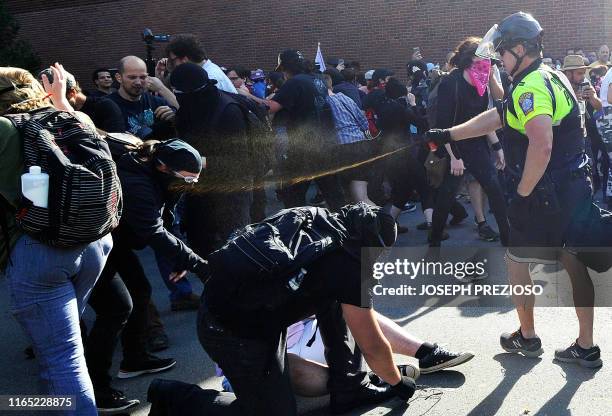 Boston Police officers use pepper spray on anti-parade demonstrators during the "Straight Pride" parade in Boston, on August 31, 2019. - "Straight...