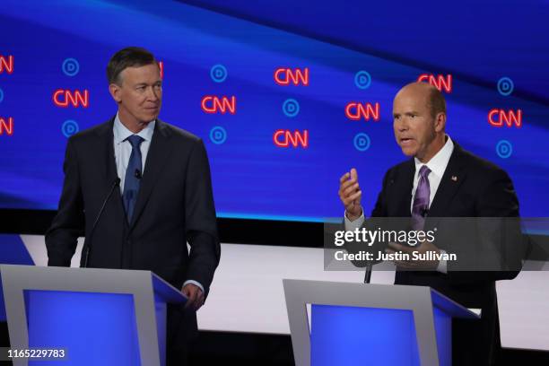 Democratic presidential candidate former Maryland congressman John Delaney speaks while former Colorado governor John Hickenlooper listens during the...