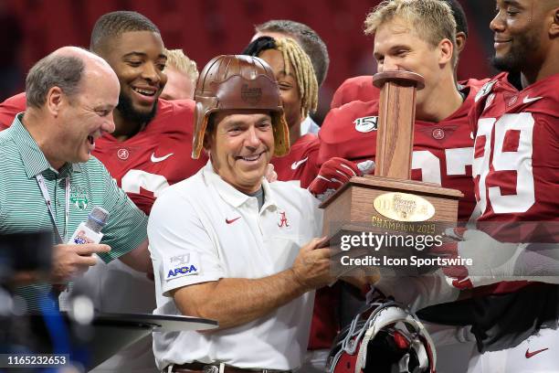 Alabama head coach Nick Saban wears the leather helmet after his Crimson Tide defeated Duke in the Chick-fil-A Kickoff Game between the Alabama...