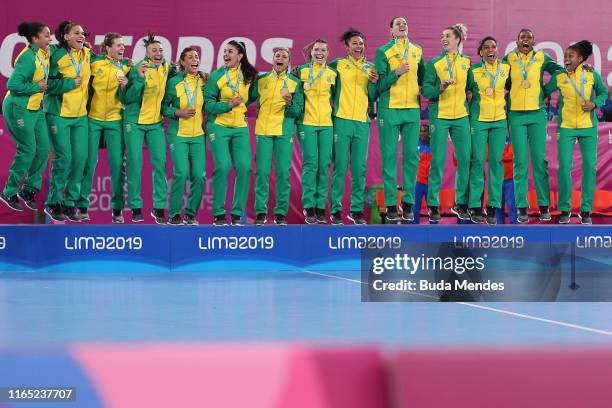 Players of Brazil celebrate in the podium after winning gold in Women's Handball Gold at Villa Deportiva Nacional - VIDENA on Day 4 of Lima 2019 Pan...