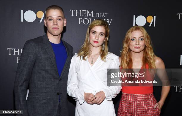 Dan Madison Savage, Alice Englert and Britt Poulton arrive at the premiere of 1091 Media's "Them That Follow" at the Landmark Theatre on July 30,...