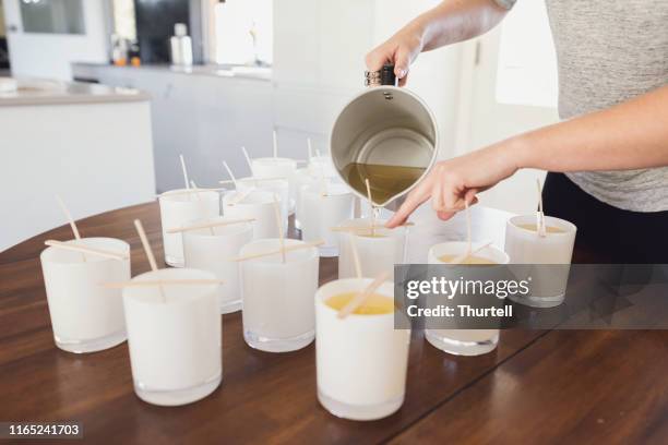 pouring wax into candle jars - candle making process - wax stock pictures, royalty-free photos & images