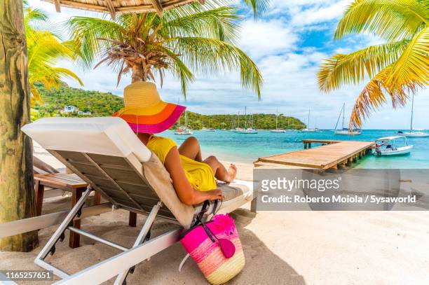 woman relaxing on beach bed, caribbean, antilles - caribbean resort stock pictures, royalty-free photos & images