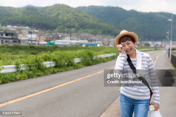 senior woman walking in the heat - heat wave elderly stock pictures, royalty-free photos & images