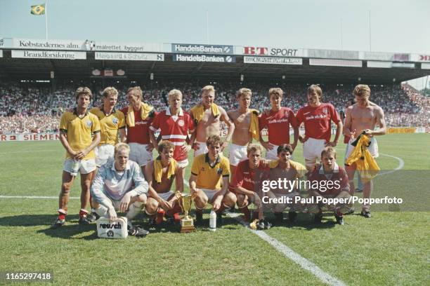 View of the Denmark national football team celebrating with the trophy after defeating Brazil 4-0 to win the Centenary Tournament at Idraetsparken in...