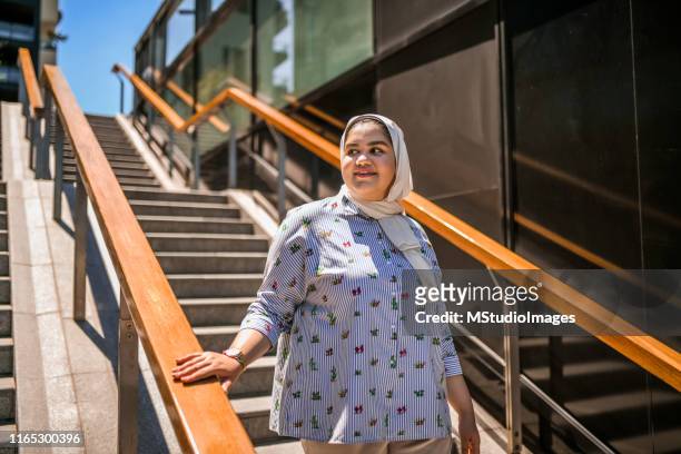 young muslim woman at the city. - plump girls stock pictures, royalty-free photos & images