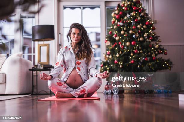 beautiful female at yoga mat, looking at camera. - christmas norway stock pictures, royalty-free photos & images