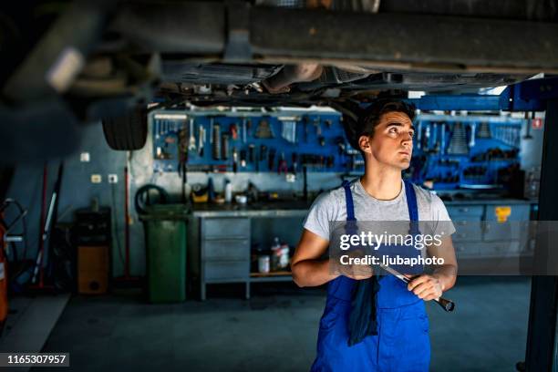 men checking car engine in auto service garage - open end spanner stock pictures, royalty-free photos & images