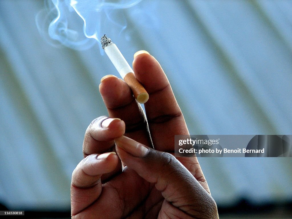 Hand holding a cigarette