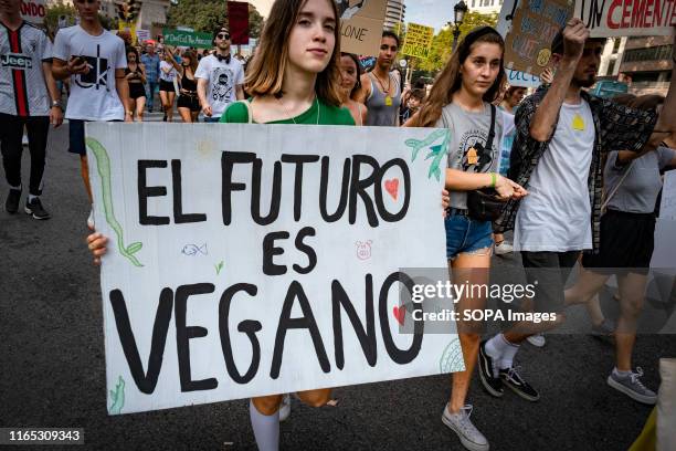 Protester holds a placard in defence of the vegan diet during the demonstration. Convened by the Barcelona Animal Save organisation hundreds of...