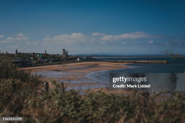 view toward the town of st andrews seen from the cliffs over the east sands - fife scotland stock pictures, royalty-free photos & images