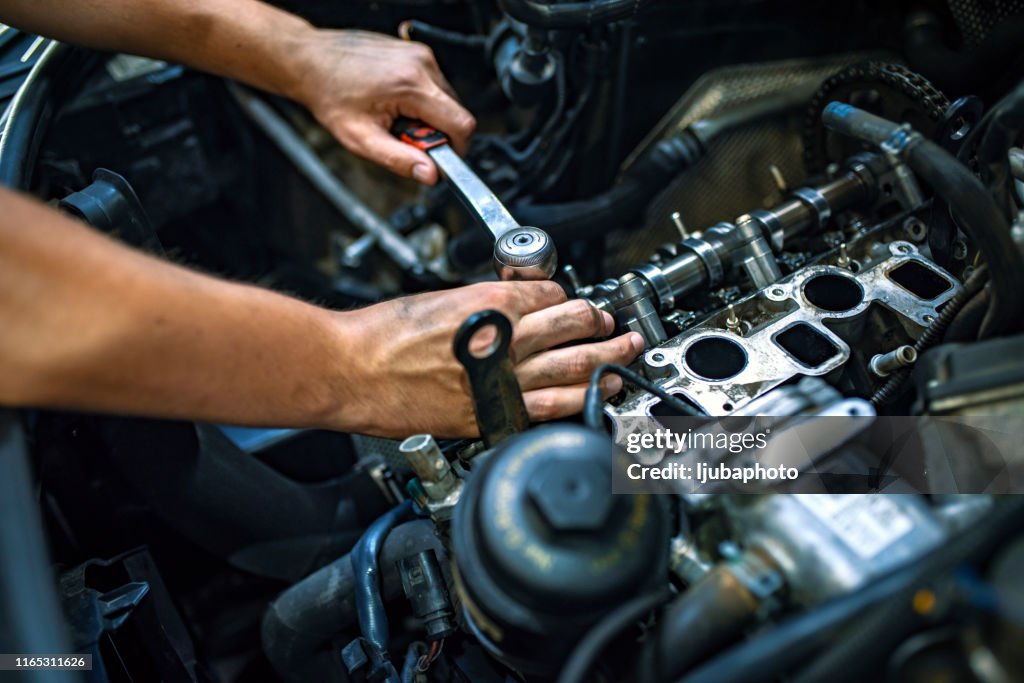 Mechanic using a ratchet wrench