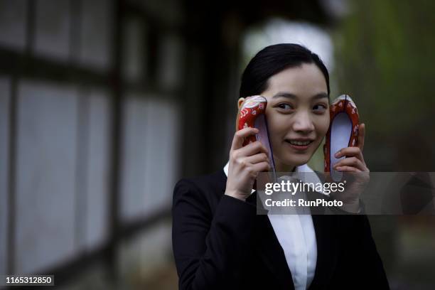 businesswoman holding korean traditional flower shoes - chuseok stock pictures, royalty-free photos & images