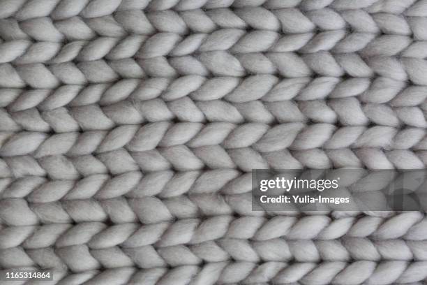 close up detail of a hand knitted garment or rug - lavorare a maglia foto e immagini stock