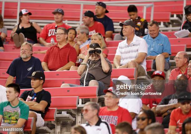 Fan with binoculars watches the game between the Southern Utah Thunderbirds and the UNLV Rebels at Sam Boyd Stadium Saturday, Aug. 31 in Las Vegas,...