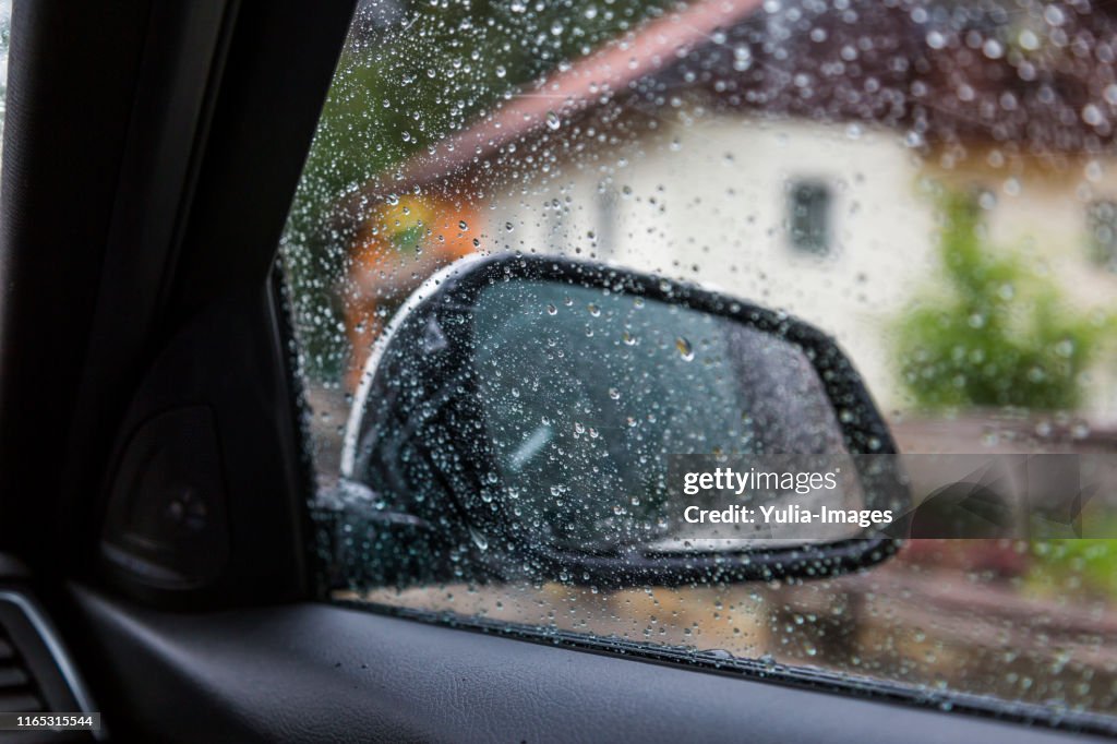 Close-up of water drops on glass window in car