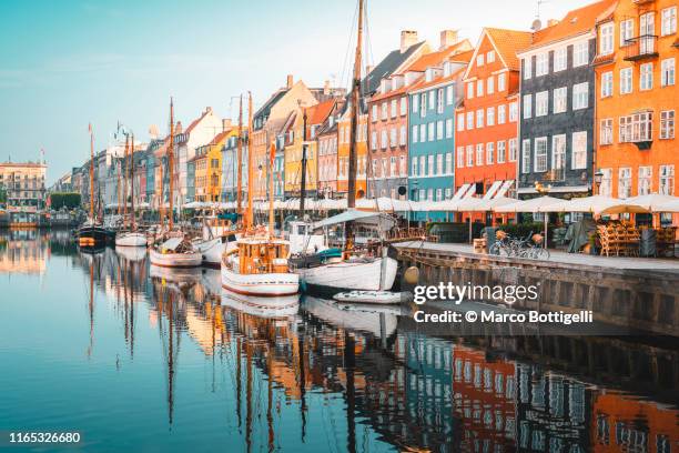 colourful townhouses facades and old ships along the nyhavn canal, copenhagen - copenhagen architecture fotografías e imágenes de stock