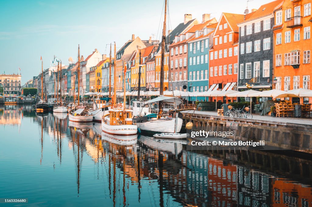 Colourful townhouses facades and old ships along the Nyhavn Canal, Copenhagen