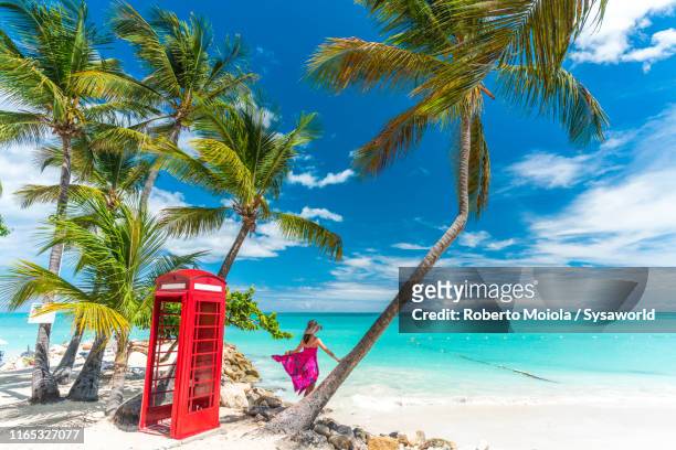 red phone box, siboney beach, antigua, caribbean - barbados beach stock pictures, royalty-free photos & images
