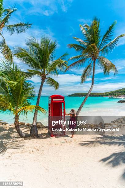 woman at phone box, siboney beach, dickenson bay, antigua - barbados stock-fotos und bilder