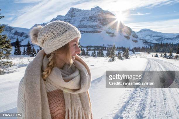portrait of girl in winter contemplating nature and enjoying snowy landscape - exhale stock pictures, royalty-free photos & images