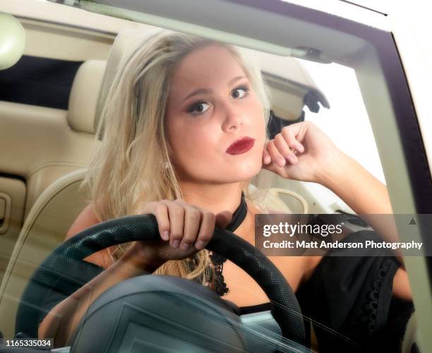young woman driving car color - movie the miserable stock pictures, royalty-free photos & images