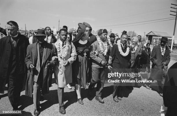 Dr Martin Luther King Jr , arm in arm with Reverend Ralph Abernathy, leads marchers as they begin the Selma to Montgomery civil rights march from...