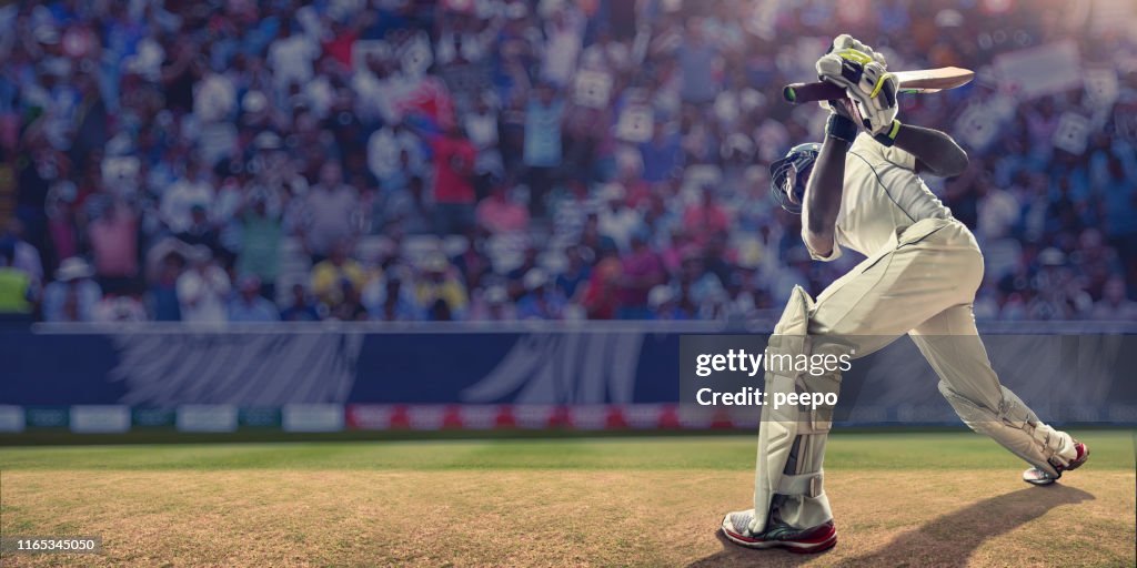 Male Cricket Batsman Having Just Hit Ball During Cricket Match