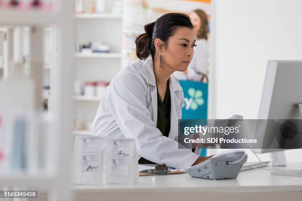 Pharmacist Using A Computer Pharmacist On Computer Photos and Premium High Res Pictures - Getty Images