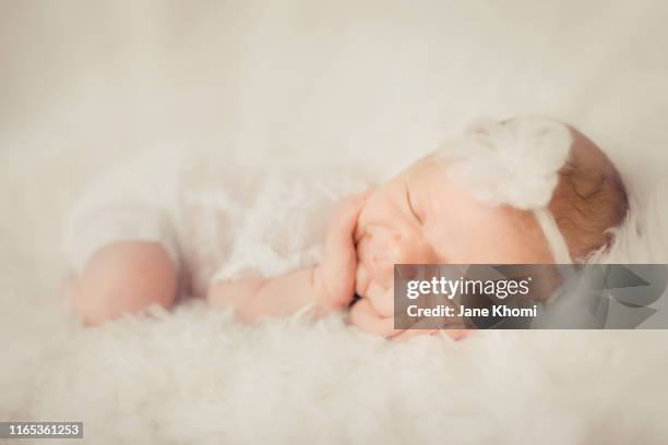 sleeping newborn baby girl wearing funny outfit - one baby girl only stock pictures, royalty-free photos & images