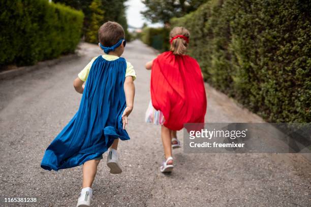children pretending to be superheroes - cape garment stock pictures, royalty-free photos & images