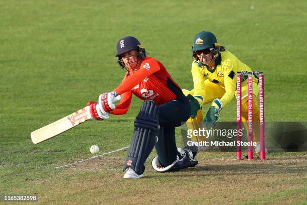 Lauren Winfield of England sweeps as Australia wicketkeeper Alyssa Healy looks on during the 3rd Vitality Women's IT20 at The County Ground on July...