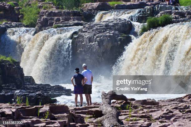 tourists visiting falls park waterfall in sioux falls, south dakota, usa - sioux falls stock pictures, royalty-free photos & images