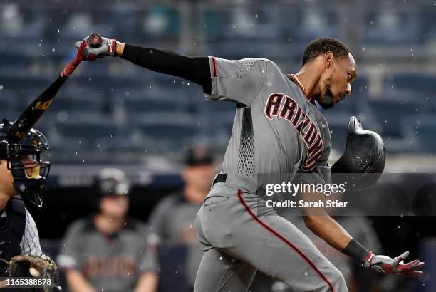 Eduardo Escobar of the Arizona Diamondbacks loses his helmet during his follow through in the fifth inning of the game against the New York Yankees...