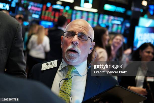 Traders react moments before the close of the New York Stock Exchange after the Federal Reserve announced a cut in interest rates on July 31, 2019 in...