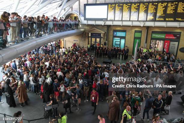 Harry Potter fans gather to watch as the Hogwarts Express appears on the departure board at London King's Cross during Back to Hogwarts Day. The day...