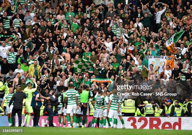 Celtic's players celebrate in front of their fans at full time during the Ladbrokes Premier match between Rangers and Celtic at Ibrox Stadium, on...