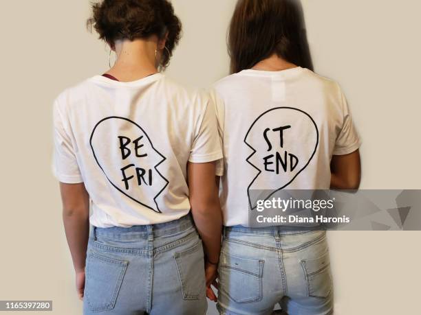 two teenage girls are wearing best friend shirts. - graphic t shirt stock pictures, royalty-free photos & images